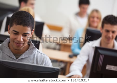 Foto d'archivio: Smiling Student In Computer Lab