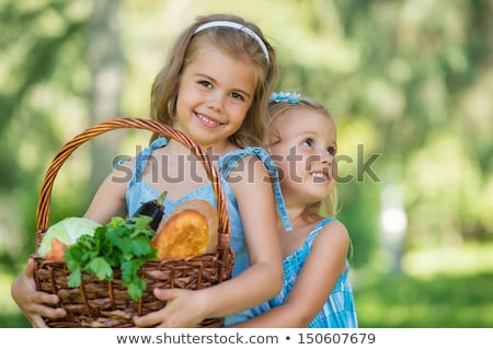 Stok fotoğraf: Two Little Girls Carrying Basket With Organic Food