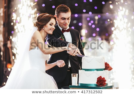 Foto stock: Girl Cutting Wedding Cake