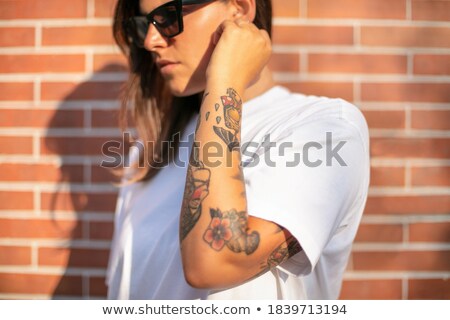Stockfoto: Back View Of Pretty Young Woman With Tattooed Hand
