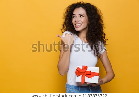 Stockfoto: Excited Happy Cute Young Woman Posing Isolated Over Yellow Background Holding Gift Box Present Point