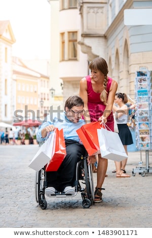 Stockfoto: Handicapped Man And His Friend Shopping In Town