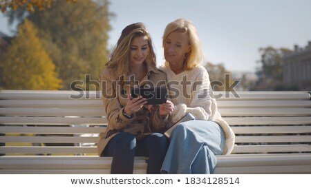 Stock foto: Grandmother And Granddaughter With Tablet At Park