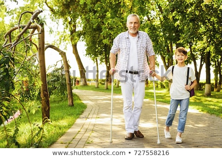 Foto stock: Handicapped Man Walking With Crutches