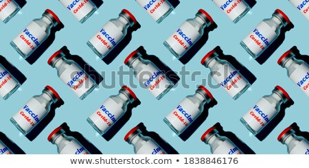 Stock photo: Disposable Syringes Of Red And Blue Vaccine With Shadows
