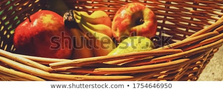 Foto stock: Organic Apples Pears And Bananas On Rustic In A Wicker Basket