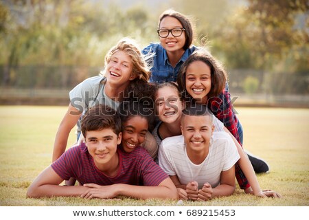 Foto d'archivio: Teenagers Lying In The Grass