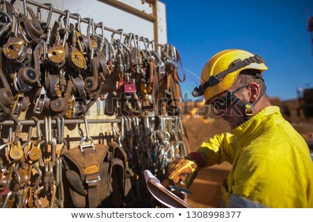 Stock photo: Adult Man Wearing Safety Equipment Descending A Rope