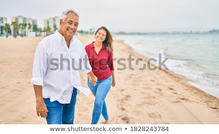 Foto stock: Woman Walking On The Beach