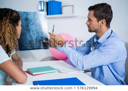 Stok fotoğraf: Male Doctor Explaining X Ray To Patient