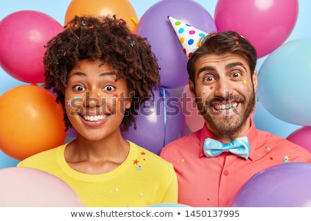 [[stock_photo]]: Happy Couple In Party Hats With Balloons