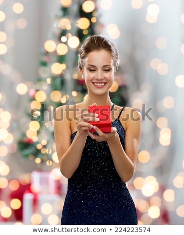 Stock photo: Happy Woman With Gift Over Christmas Tree