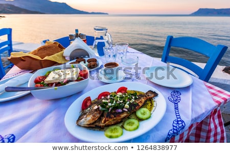 Foto d'archivio: Greek Salad Plate And White Wine