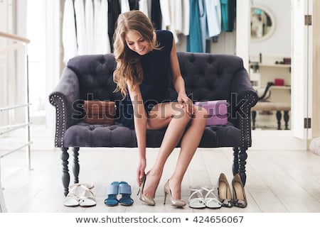 Stock photo: Young Woman Trying High Heeled Shoes At Store