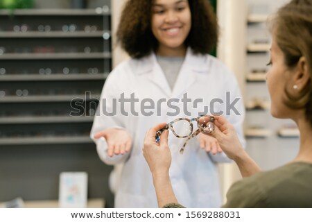Сток-фото: Woman Holding Stylish Eyeglasses While Clinician In Whitecoat Consulting Her