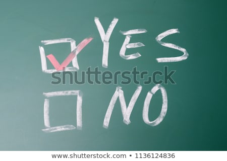 Foto stock: Yes And No Check Boxes Written On A Blackboard