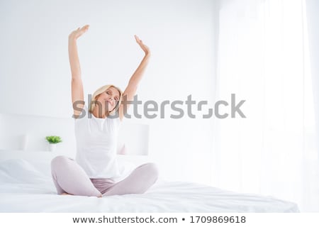 Stock photo: Woman Stretching As She Practices Yoga