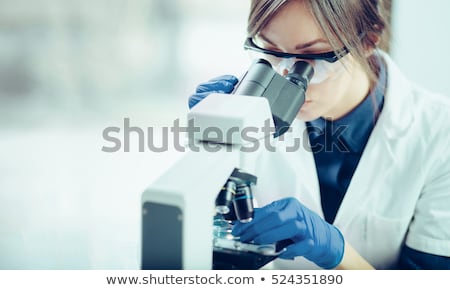 Foto stock: Woman Working With A Microscope