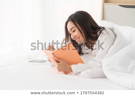 Stock foto: Portrait Of Lying Down Woman With A Journal