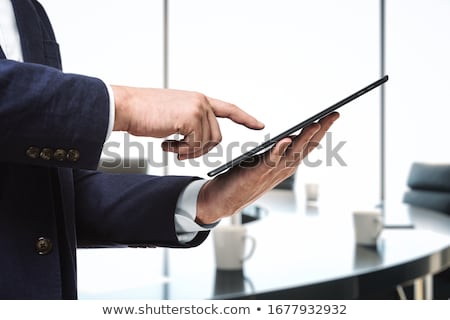 Foto stock: Hand Touching Tablet With Global Estate Report Concept