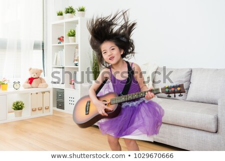 Stok fotoğraf: Energetic Little Girl Jumping High Into The Air