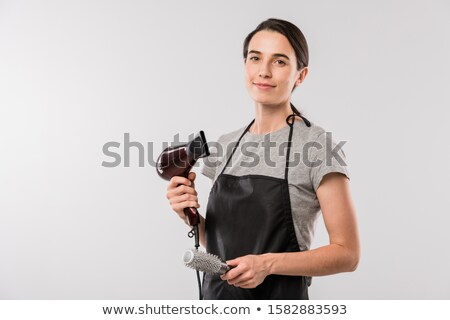 Stockfoto: Young Professional Hairdresser In Workwear Holding Hairbrush And Hairdryer