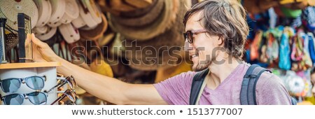 Stock foto: Man Traveler Choose Souvenirs In The Market At Ubud In Bali Indonesia Banner Long Format