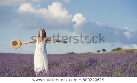 Foto stock: Smiling Woman Wearing Blue Dress On A Field