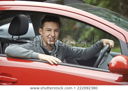 Imagine de stoc: Newly Qualified Teenage Boy Driver Sitting In Car