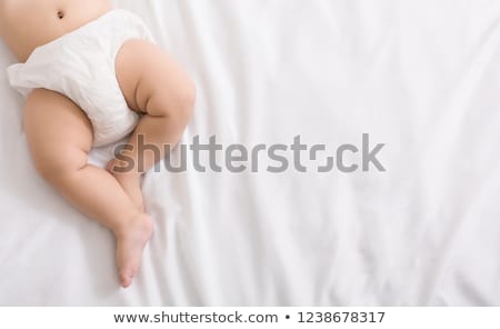 Сток-фото: Beauty Little Boy In White Diaper Lies On Belly