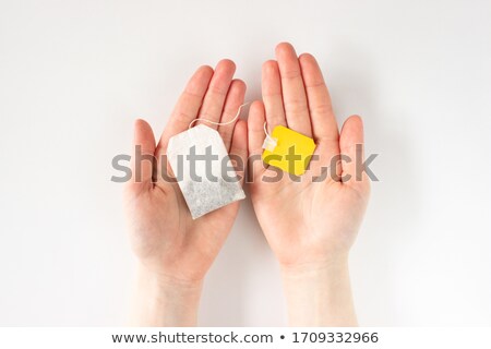 Stock fotó: Female Hand Hold Loose Healthy Black Tea On White