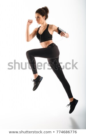 Stock photo: Concentrated Curly Brunette Fitness Woman Running In Studio