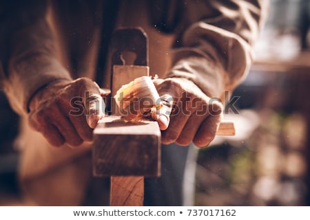 Stok fotoğraf: Carpenter Working With Plane And Wood At Workshop