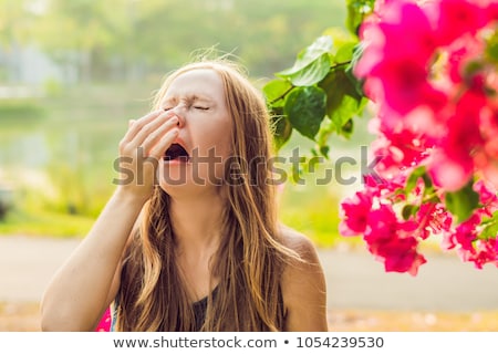 Foto stock: Pollen Allergy Concept Young Woman Is Going To Sneeze Flowering Trees In Background
