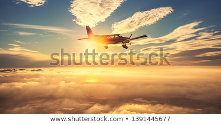 Zdjęcia stock: Jet Is Maneuvering In Spectacular Sunset Sky