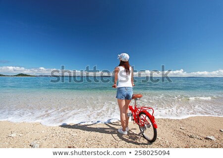 Happy Young Attractive Woman Relaxing On The Bicycle Trip On The Beach Stock foto © sunabesyou