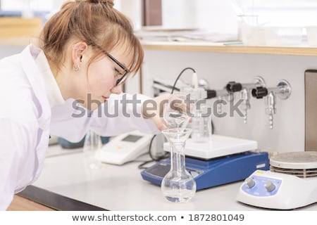 Stockfoto: Assistant Pours Reagent In The Flask