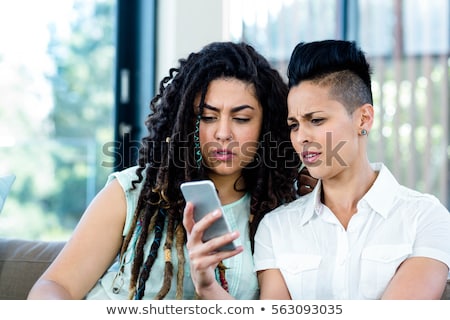 ストックフォト: Close Up Of Lesbian Couple Sitting On Sofa At Home