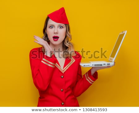 Foto stock: An Air Hostess Wearing A Red Uniform