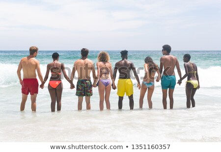 Stock photo: Shirtless Male Friends Talking While Standing At Beach