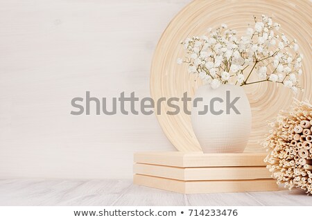 Imagine de stoc: Soft Home Decor Of Beige Bamboo Dish And White Small Flowers In Ceramic Vase On White Wood Backgrou