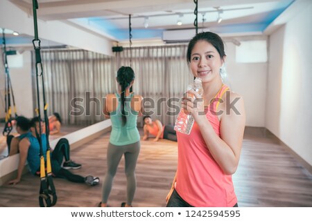 Foto d'archivio: Woman Taking A Fitness Workout Rest With Trx Straps