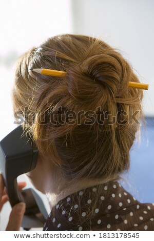 Stock photo: Businesswoman With Hair Bun And Telephone