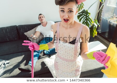 Zdjęcia stock: Wife Is Mad At Her Lazy Husband Who Is Not Helping With Chores