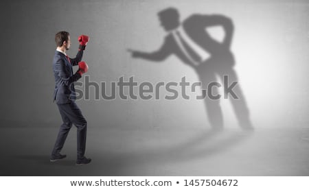 Foto d'archivio: Businessman Fighting With His Bossy Shadow