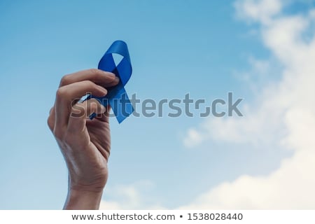Foto stock: Hand Holding Diabetes Awareness Blue Ribbon