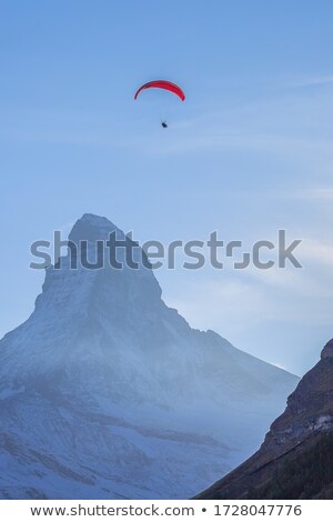 Сток-фото: Red Paraglide In Blue Sky Over Alps Peaks