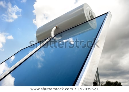 Stockfoto: Hot Water Boiler With Solar Panel On Roof