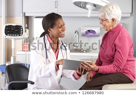 ストックフォト: Black Woman Doctor With Patient Records