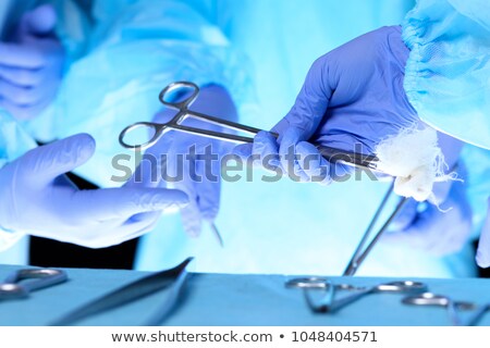 Stok fotoğraf: Surgeon Holding Surgical Tool In Operation Room